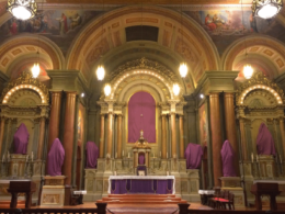 The statues in a Church are veiled in purple cloths during Passiontide