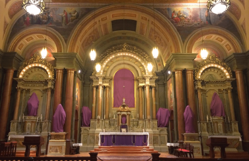 The statues in a Church are veiled in purple cloths during Passiontide