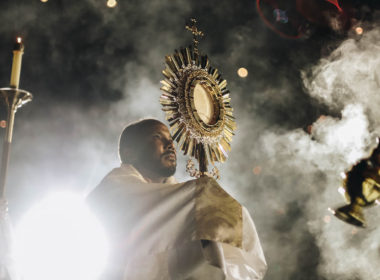 Priest holding the Blessed Sacrament