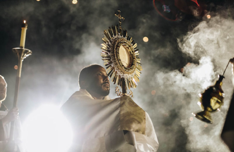 Priest holding the Blessed Sacrament