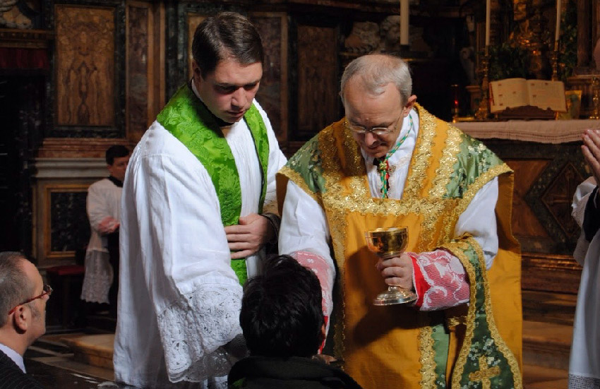 Bishop Schneider serving Holy Communion