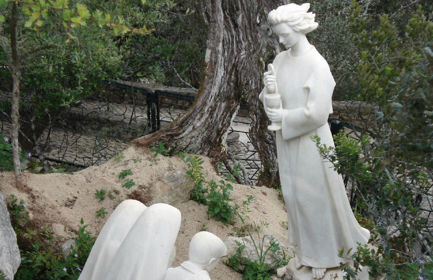 The statue of Angel of Fatima giving the Holy Eucharist to the shepherd childrem